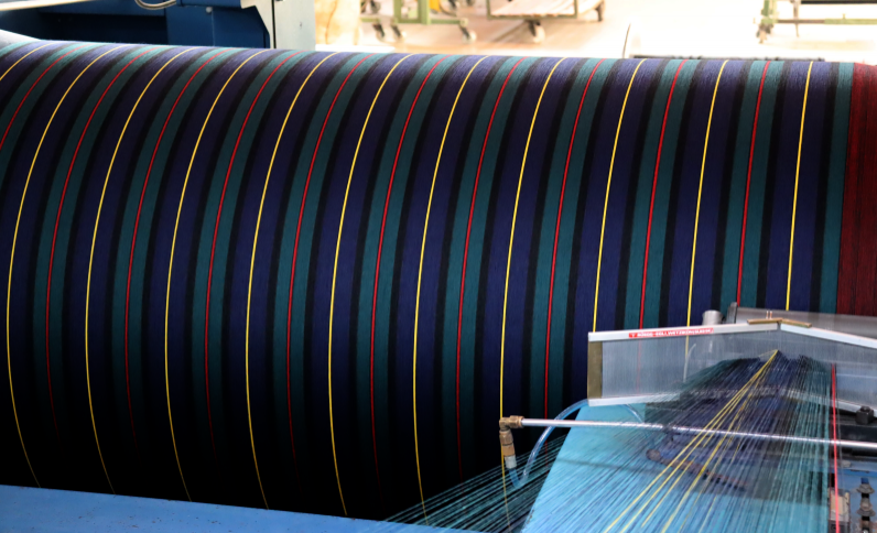 The yarn strips are extended to produce a warp…