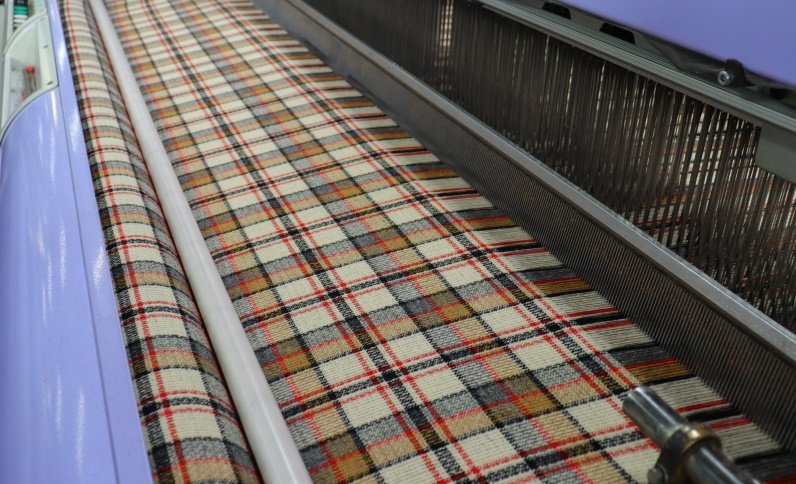 Our looms come into action, crossing warps with wefts, to create the planned fabric...